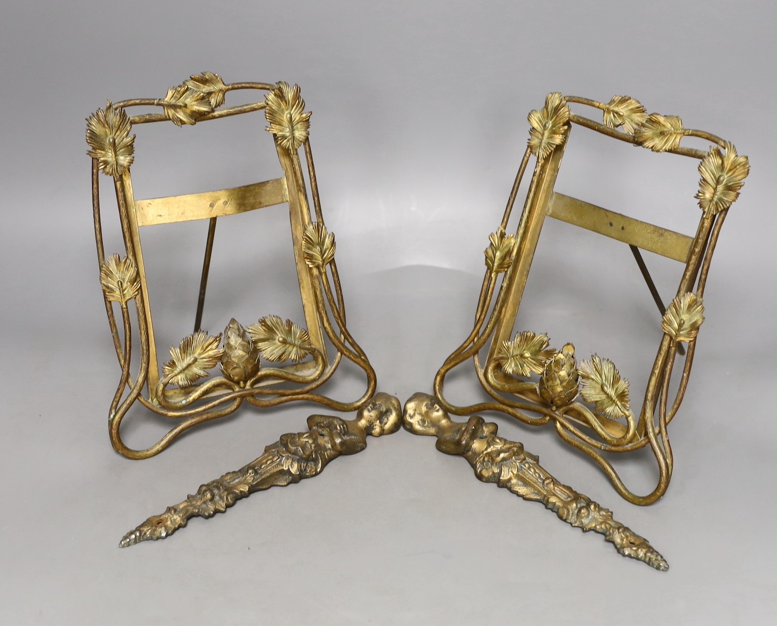 A pair of late 19th century brass photo frames, 20.5 cm high, and a pair of bronze furniture mounts